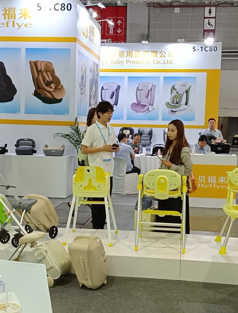 Discussing High Chair Features with a Booth Visitor